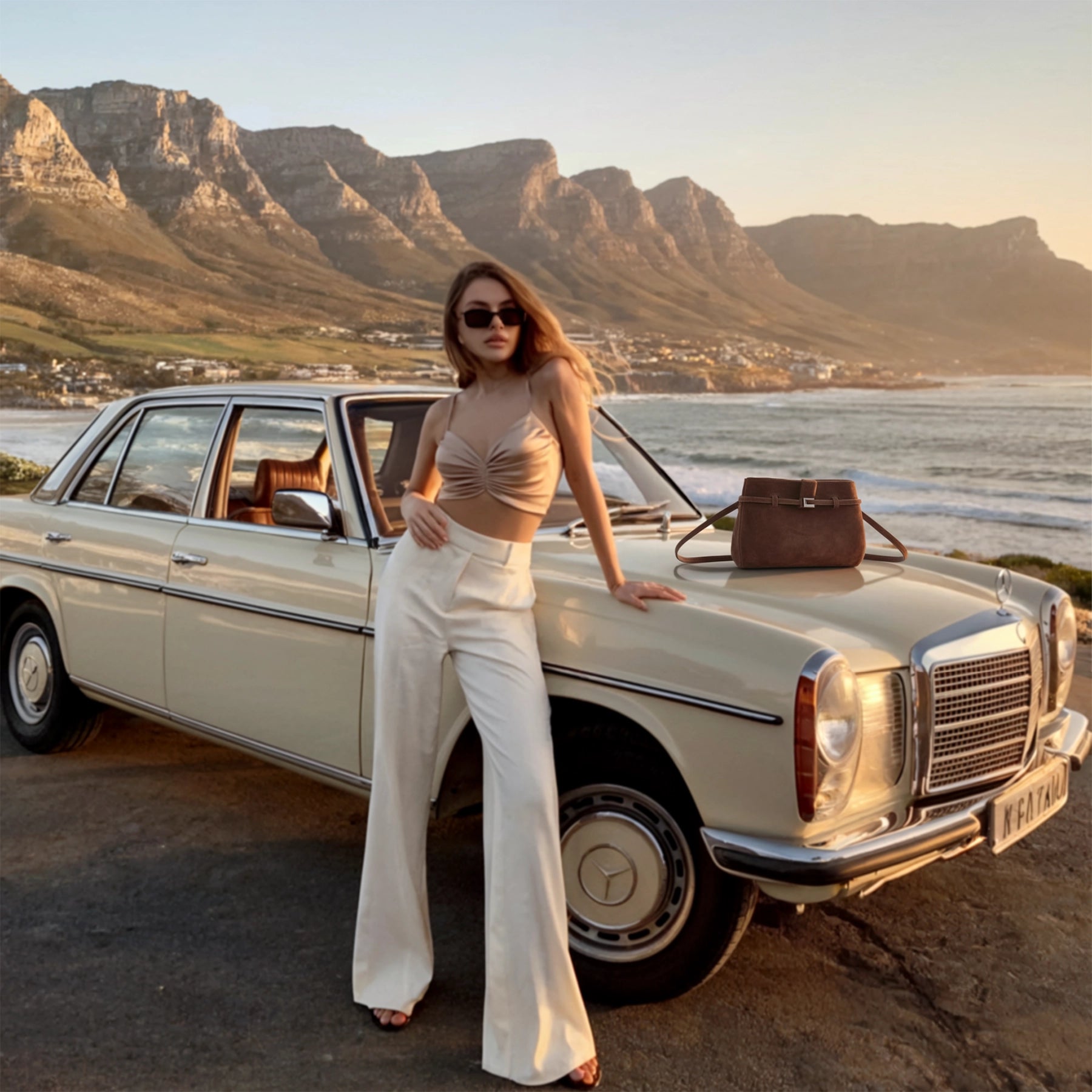 Woman standing next to a vintage car with Table Mountain in the background